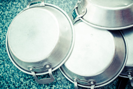 Aluminium pans for cooking on the table in kitchen close up. (Processed in vintage colour tone)の写真素材