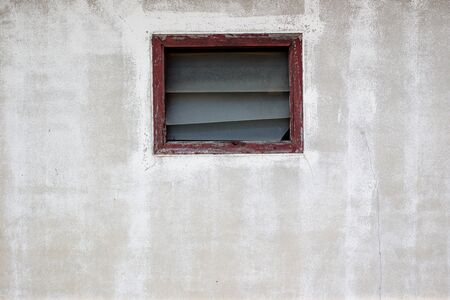 Old broken window on a wall close up background.