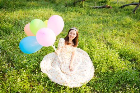 Beautiful lady in princess concept in the forest with a colorful balloon.の写真素材
