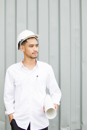 Portrait of professional engineer holding a blueprint in hand.の写真素材