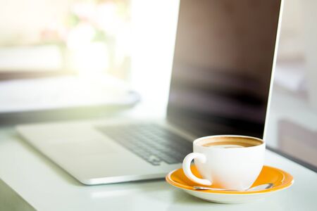 Cup of coffee and smart devices on the table close up.の写真素材