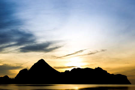 Landscape of a big mountain a long the sea during sun rise background.