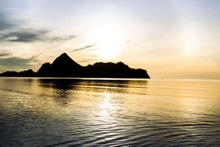 Landscape of a big mountain a long the sea during sun rise background.