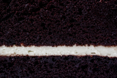Layer of chocolate and milk cream cake close up.の写真素材