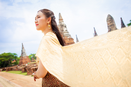 Beautiful Thai lady in the traditional Thai dress close up.の写真素材