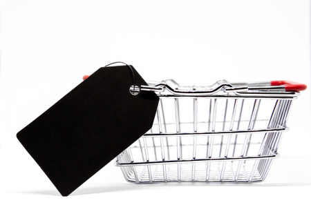 Modern stainless shopping cart with a price tag beside close up.の写真素材