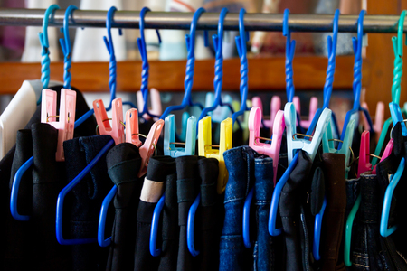 Jeans and trousers hanging on the clothes line close up.の写真素材