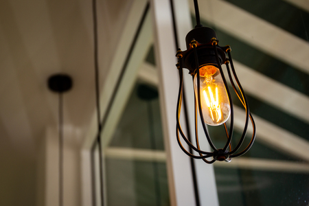 Vintage light bulbs hanging from ceiling decorated in the room.の写真素材