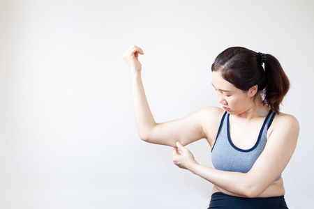 Fat Asian girl concern for her fat under her arm. Unhealthy concept.の写真素材