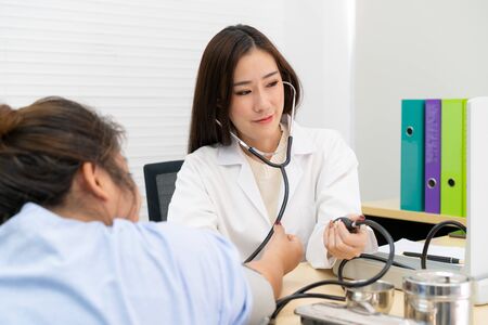 Asian woman doctor examining on fat woman in hospital close up.