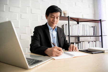 Asian senior businessman working at office.の写真素材