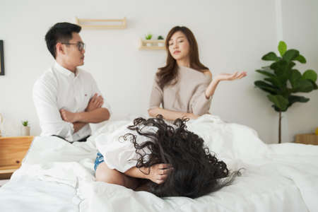 Serious relationship in Asian family between husband and wife, children abuse cause of divorce parent. Divorce relationship in family. Girl live in the situation of critical abuse relationship.の写真素材