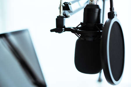 Mockup laptop computer with empty blank screen isolated with clipping path set up in the audio sound recording studio. Live steaming and podcast internet radio studio.の写真素材