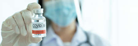 Doctor showing a vaccine on hand close up with copyspace.の写真素材
