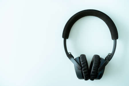 Modern wireless on ear headphones on white table close up. Professional stereo wireless headphone.の写真素材