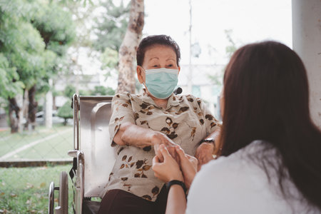 Young granddaughter taking care of grandmother with tender and care. Wrinkled hands of very old...