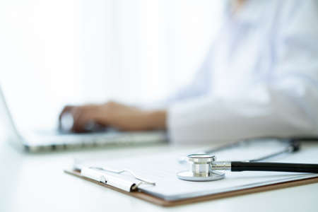 Medical stethoscope left in the doctor office in hospital close up with copy space. Health care and medical service concept.の写真素材