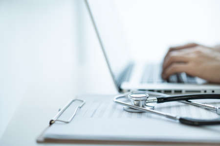 Medical stethoscope left in the doctor office in hospital close up with copy space. Health care and...
