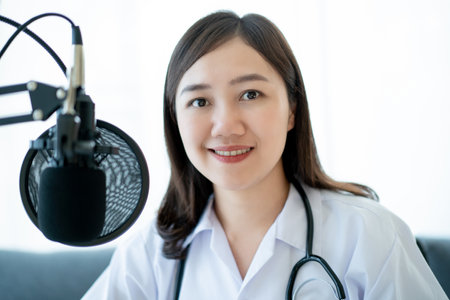 Asian doctor making an online video conference with her patient, tele medical service concept. Female doctor making a medication advise via online podcast.の写真素材