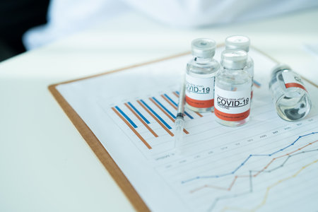 COVID-19 or coronavirus cure vaccine analysis in statistics report concept. Copy space in photo. COVID19 vacination report.の写真素材