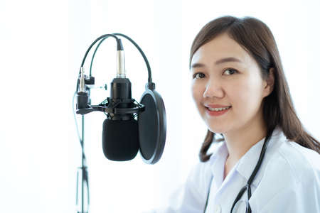 Asian doctor making an online video conference with her patient, tele medical service concept. Female doctor making a medication advise via online podcast.の写真素材