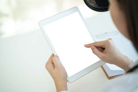 Mockup isolated with clipping path blank screen of tablet. Doctor showing and pointing on tablet, empty blank screen tablet. Healthcare and wellness concept.の写真素材