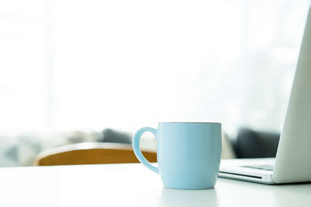 Hot black coffee in the blue coffee mug on the table close up with copyspace. Hot americano coffee in the blue ceramic coffee mug close up.の写真素材