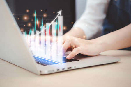 Asian young business woman reviewing - analyzing the financial data on laptop computer close up....