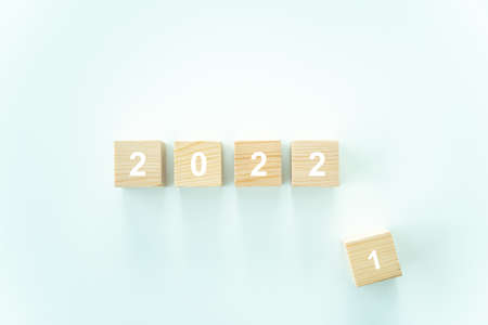 2021 - 2022 word on the wooden blocks on white background, concept of happy new year 2022 celebrating and good bye the current year 2021.の写真素材
