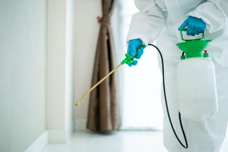 Sanitary staff sanitizing a surface inside the building cause virus disease pandemic. Cleaning...