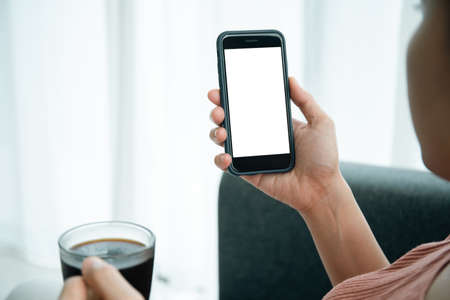 Mockup smartphone with isolated blank screen. Young Asian woman texting and exploring social media...