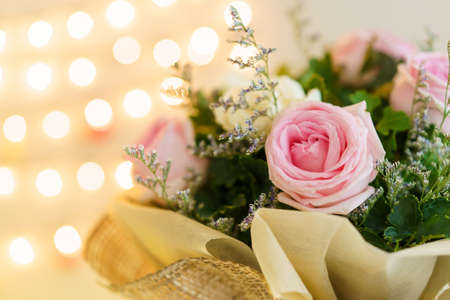 Beautiful bouquet of yellow - orange rose. Fresh roses in a vase decorated on the table close up.の写真素材
