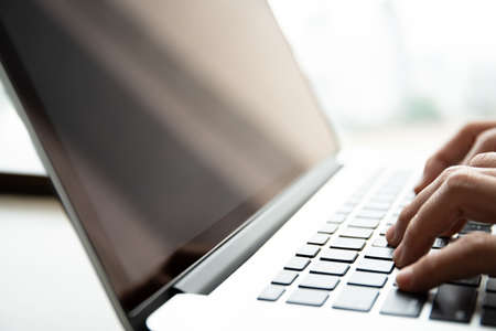 Happy Asian young woman making a video conference on laptop computer while living in the living room, cheerful Asian woman making a gesture or hands sign in video call.の写真素材