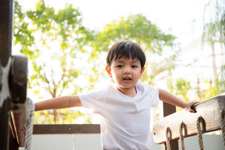 Happy Asian little boy enjoy playing and walking at the park. Little boy portrait at the park and...