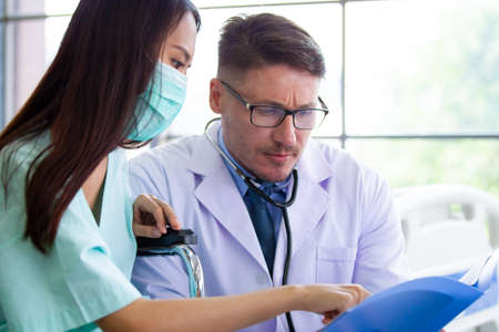 Asian woman got a sickness from flu virus having a consultation with professional doctor in hospital. Doctor explaining about healthcare and sickness avoidance. Medical consultant service.の写真素材