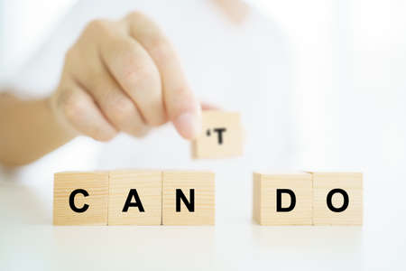 Positive thinking concept, man using a hands separated the word between "can" and "not". Can do attitude concept.の写真素材