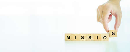 Positive word on wooden blocks "success", an unrecognizable businessman putting the last "S" letter on a wooden cube into the word success close up.の写真素材