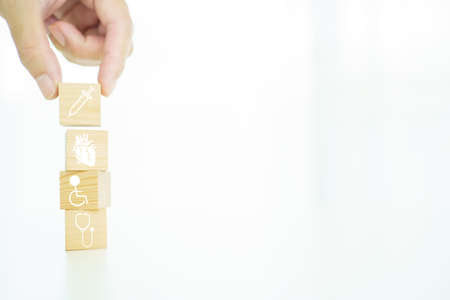 Health care and wellbeing concept in icon on wooden block with copyspace.の写真素材