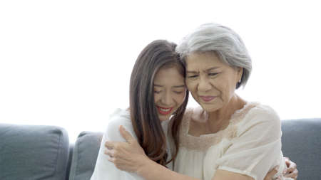 Happy Asian family concept, daughter embracing and taking care her mother. Wellness - mental health in senior or elder people.の写真素材
