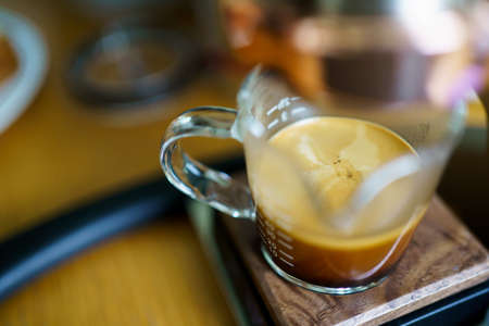 Barista brewing the espresso coffee by using high pressured espresso machine in a small coffee shop. Coffee machinery in coffee shop.の写真素材
