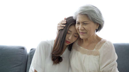 Happy Asian family concept, daughter embracing and taking care her mother. Wellness - mental health in senior or elder people.の写真素材