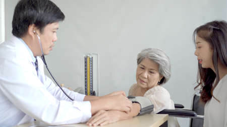 Elder woman talking and having a consulting to doctor about disease. Wellness and health care concept.の写真素材