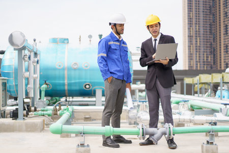 Professional Asian foreman and construction manager talking - discussing about building structure plant together. Businessman and construction engineer having a discussion.の写真素材
