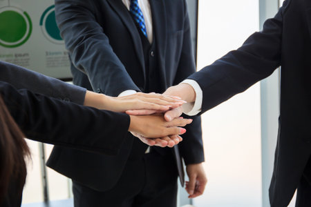 Happy Asian senior businessman making an annual or fiscal year business plan meeting together and clapping a hands. Cheerful executive businessmen and businesswomen discussing about their business.の写真素材