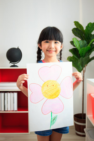 Happy caucasian and Asian young elementary school age enjoy learning and playing in their classroom with their teacher. Boys and girls studying arts and mathematics in classroom.の写真素材