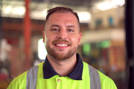 Happy caucasian white male factory worker or engineer portrait, a senior professional engineer or foreman portrait in factory.の写真素材