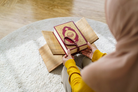 Beautiful Asian young Muslim woman sit on the floor in her house and praying for a holy god - Allah in Islam believe.の写真素材