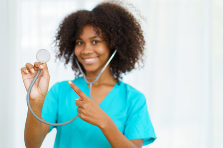 Beautiful American - African black ethnicity female doctor standing in the hospital portrait with copyspace. Surgery female doctor portrait at hospital.の写真素材