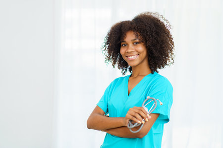 Beautiful American - African black ethnicity female doctor standing in the hospital portrait with copyspace. Surgery female doctor portrait at hospital.の写真素材