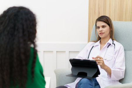 Female specialist or professional doctor giving a consulting to female patient in clinic.の写真素材